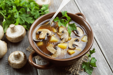 Mushroom soup with champignons in the bowl on the tableの写真素材