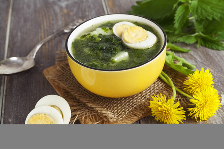Soup of nettles on the wooden tableの写真素材