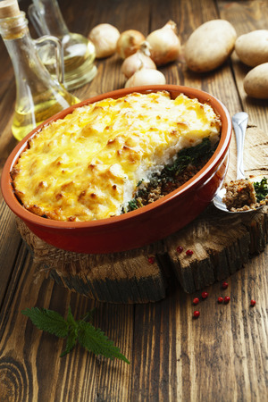 Potato casserole with meat and nettle on the  tableの写真素材