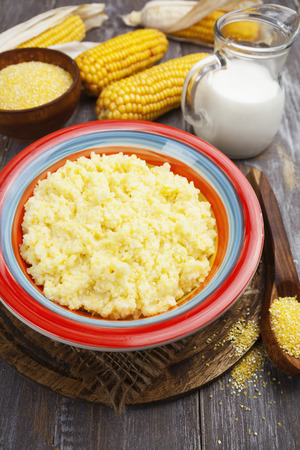 Fresh corn meal in the plate on the tableの写真素材