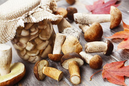 Canned mushrooms in a glass jar on the tableの写真素材