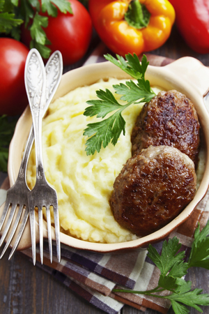 Cutlets with potato puree in a ceramic potの写真素材