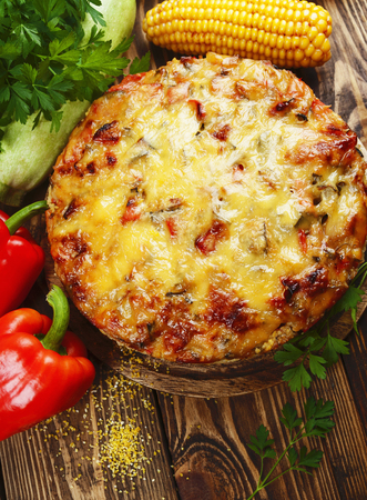 Casserole of polenta, zucchini and paprika on the tableの写真素材