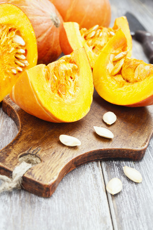 Small beautiful orange pumpkins on the kitchen tableの写真素材