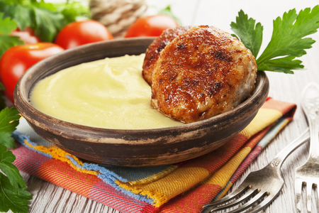 Cutlets and mashed potatoes in the ceramic plateの写真素材