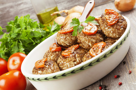 Meat cutlets with cabbage and rice on the tableの写真素材