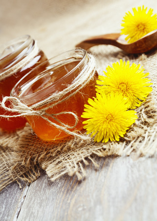 Jelly of dandelions in a glass jar on the tableの写真素材