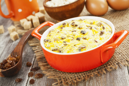 Cottage cheese casserole in a ceramic pot on a tableの写真素材