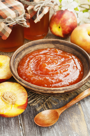 Fresh nectarines jam on a wooden tableの写真素材