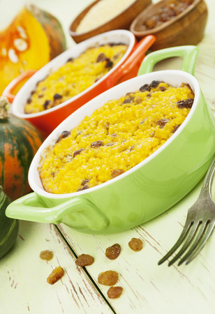 Pumpkin casserole with millet and raisin on the wooden tableの写真素材
