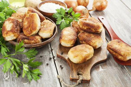 Fried pastry with potato on the tableの写真素材