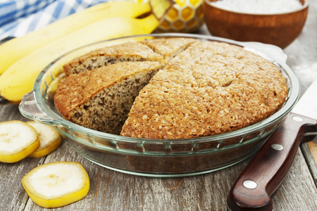 Banana cake and fresh bananas on the tableの写真素材