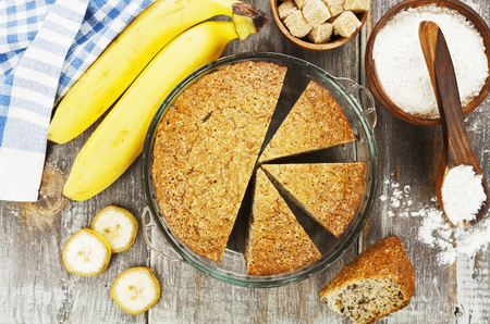 Banana cake and fresh bananas on the tableの写真素材