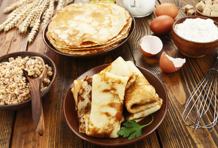 Crepes stuffed with meat on the wooden tableの写真素材