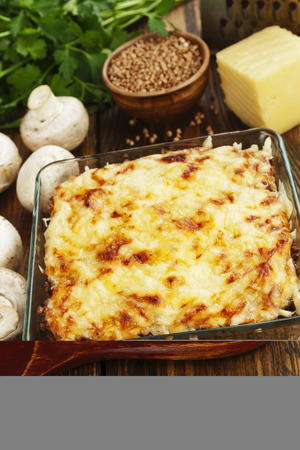 Buckwheat casserole with chicken and mushrooms on the tableの写真素材