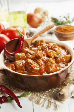 Meat stew with chili pepper in tomato sauceの写真素材