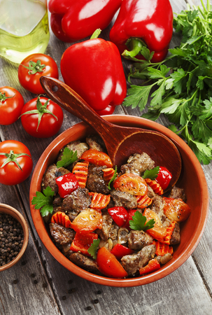Chicken liver with sweet pepper and tomatoes on the tableの写真素材