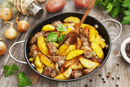 Potatoes stewed with chicken liver on the tableの写真素材