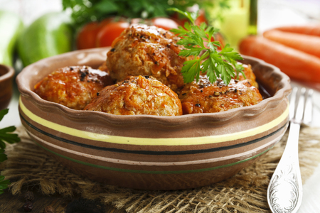 Meatballs with vegetables and tomato sauce on the tableの写真素材