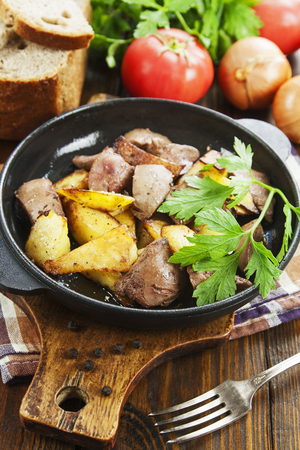 Potatoes stewed with chicken liver on the tableの写真素材