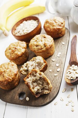 Banana muffins with oat flakes on the tableの写真素材