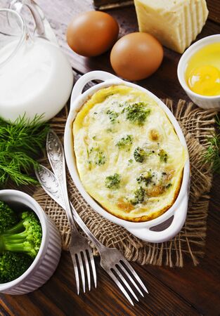 Broccoli baked with eggs and cheese in a ceramic potの写真素材