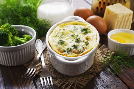 Broccoli baked with eggs and cheese in a ceramic potの写真素材
