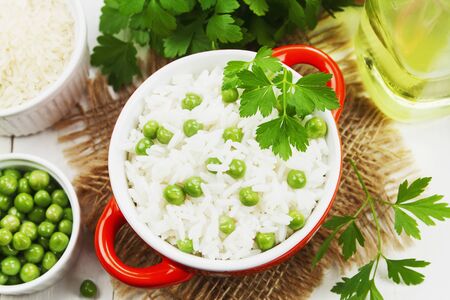Rice with green peas on the tableの写真素材