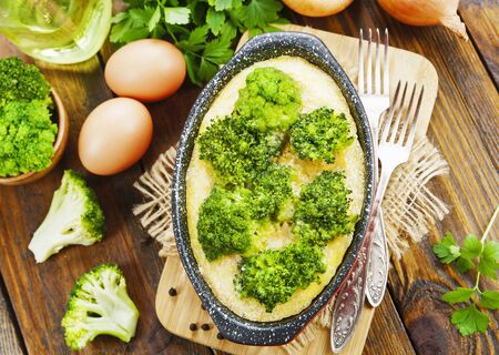 Casserole with broccoli and eggs on the tableの写真素材