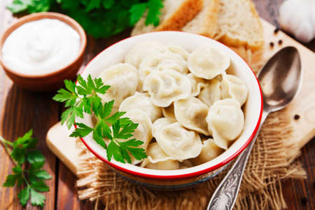 Delicious dumplings in the pot on the tableの写真素材