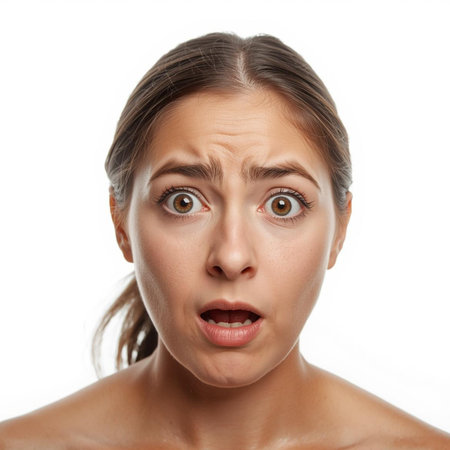 Closeup portrait of a shocked woman looking at camera isolated on white backgroundの素材