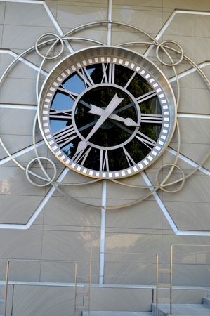 Beautiful city clock on a stone wall.の写真素材