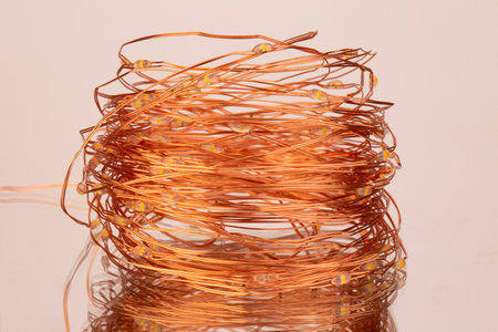Copper wire isolated on a white background. close-up. christmas lighting. Party holiday decoration lights. LED lights. decorative light bulbs. vintage lighting decorの写真素材