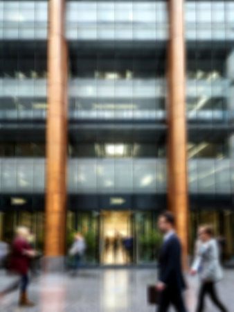 Abstract blurred background of business people walking in front of modern office buildingの素材