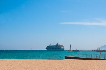 Sunny day on the beach with the cruise on the horizonの写真素材