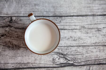 A cup of milk on the wooden backgroundの写真素材