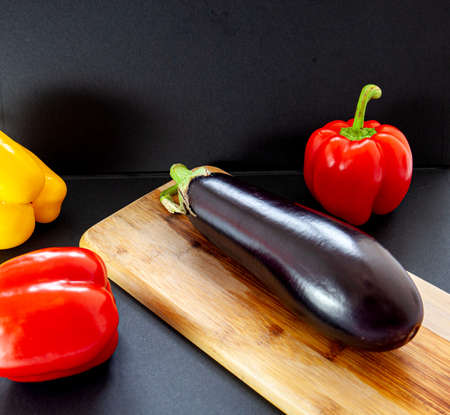 Close-up of eggplant with fresh vegetables colorful peppersの写真素材