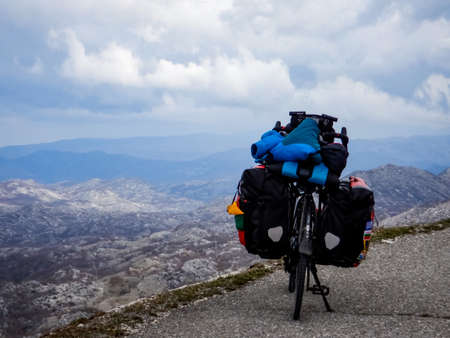 Bicyclist with backpack on the top of the mountain.の写真素材