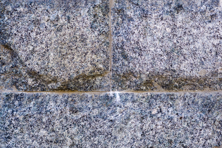Wall texture of tiled granite stone bricksの写真素材