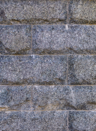 Wall texture of tiled granite stone bricksの写真素材