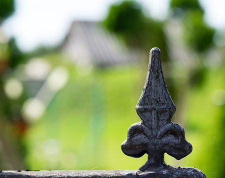 beautiful fence decoration. Image of a decorative cast iron fence. metal fence close up. Metal Forged Fence. beautiful fence with artistic forgingの写真素材
