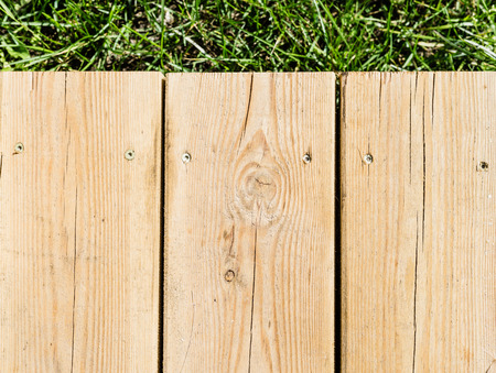 wood plank texture background laying on the grassの写真素材