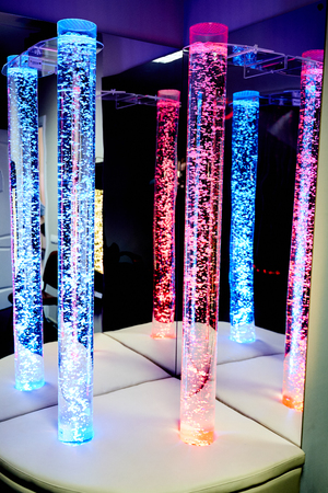 therapy sensory stimulating multi sensory room with colored lights bubble tube lamp during therapy healthcare retirement home sessionの写真素材