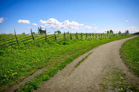 Green lanscape with one old windmill and blue sky, Russiaの写真素材