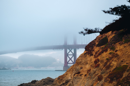 Golden Gate from Baker beach with fog dayの写真素材