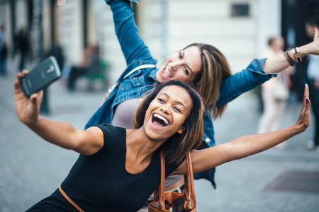 Multi ethnic Friends having fun in city taking selfie Multi ethnic Friends having fun in city taking selfie