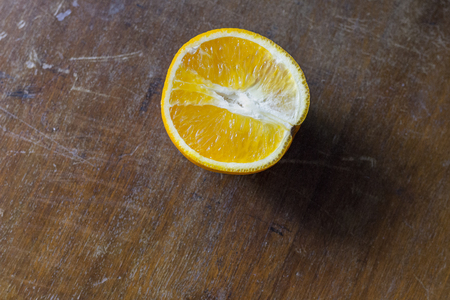 The orange is on the old table. The texture of the old boardの写真素材