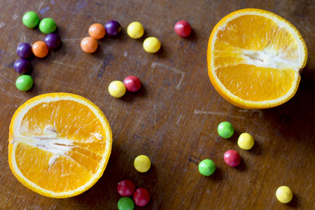 Orange slices are on the old table. The texture of the old boardの写真素材