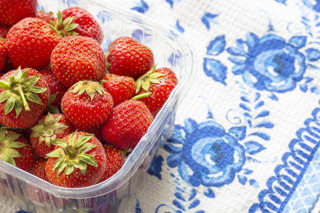 Juicy strawberries on a tablecloth with a blue patternの写真素材