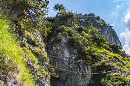 Sports via ferrata near the valley with a suspension bridge and a great view of the Berchtesgaden mountains.の写真素材